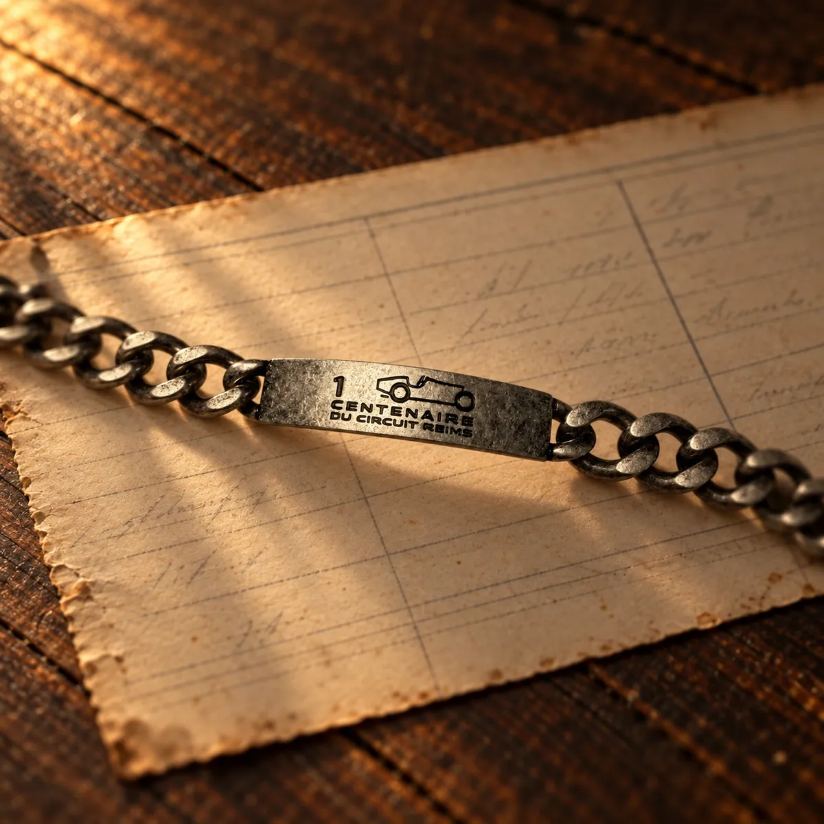 1 CENTENAIRE DU CIRCUIT REIMS – graviertes Edelstahl-Armband auf einer alten Zeitnahme-Tafel, Gestaltungsentwurf